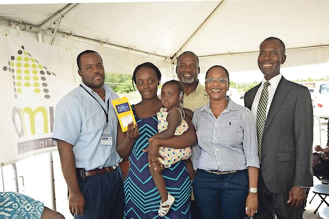 Philip Smith, Executive Director of Bahamas Feeding Network; Renee Bastian, vice president of marketing, AML Foods Ltd; Pastor Paul Mullings, of Mt Caravel Baptist Church; a single mother who was a recipient of a $100 food voucher; and the manager of Solomon’s Wholesale, Freeport, at Thursday’s presentation. 
Photo courtesy of Derek Carroll/Barefoot Marketing 