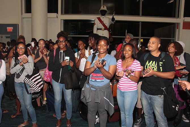 Happy Bahamian students back at Lynden Pindling International Airport on Saturday night after being brought home by Bahamasair from Jamaica, which is threatened by Hurricane Matthew. Photo: Eric Rose/BIS
 