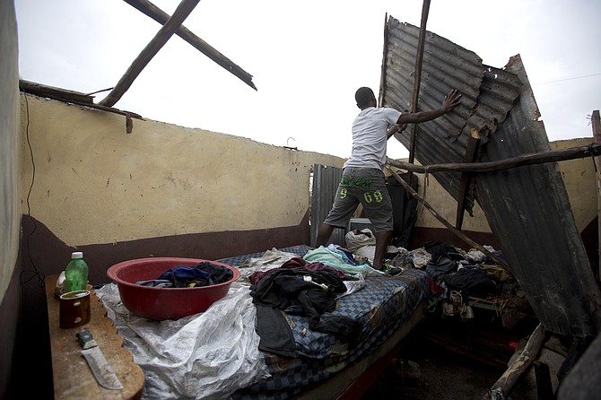 A resident repairs his home destroyed by Hurricane Matthew in Les Cayes, Haiti, on Thursday. Photo:Dieu Nalio Chery/AP