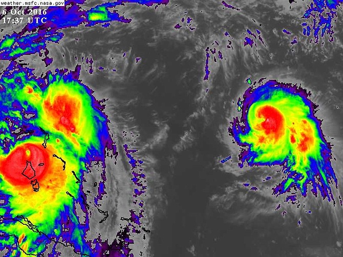 Hurricane Nicole (far right), the sixth hurricane of the Atlantic season, was more than 700 miles east of Hurricane Matthew (far left) at 1.37pm. Photo: NASA/MSFC Earth Science Office.