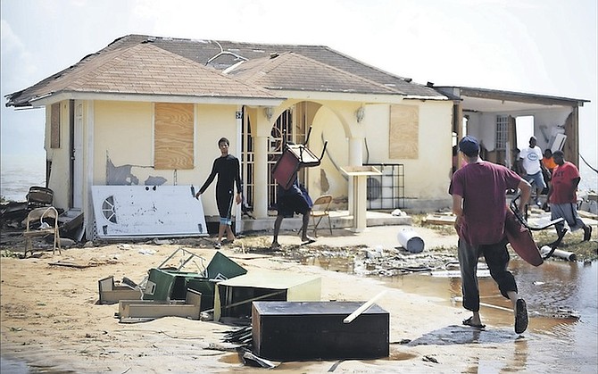 People move in to clear up at the United Fellowship Outreach Ministries International on South Beach Road, which was among many properties hit hard by Hurricane Matthew. 
Photos: Shawn Hanna/Tribune Staff