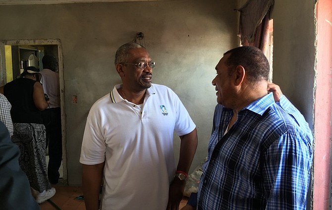 Standing in a damaged home in Lowe Sound, North Andros, Dr Hubert Minnis and Prime Minister Perry Christie share concerns over the massive destruction caused by Hurricane Matthew during an assessment trip on Saturday. Photo: NEMA