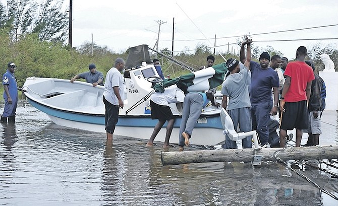 A boat in the middle of a road in Grand Bahama amid downed power lines and flood water, as residents start to clean up. 
Photo: Vandyke Hepburn