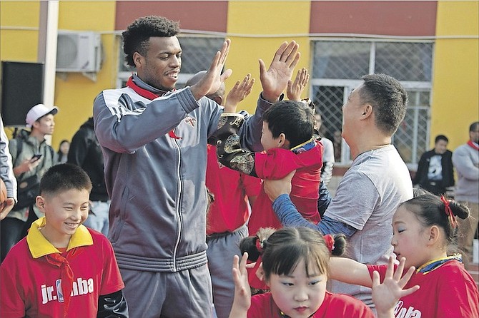 New Orleans Pelicans guard Buddy Hield interacts with children after a dedication ceremony for a NBA Cares Learn and Play Center at the Huangzhuang Migrant School in Beijing, China, on Tuesday. (AP Photo/Ng Han Guan)