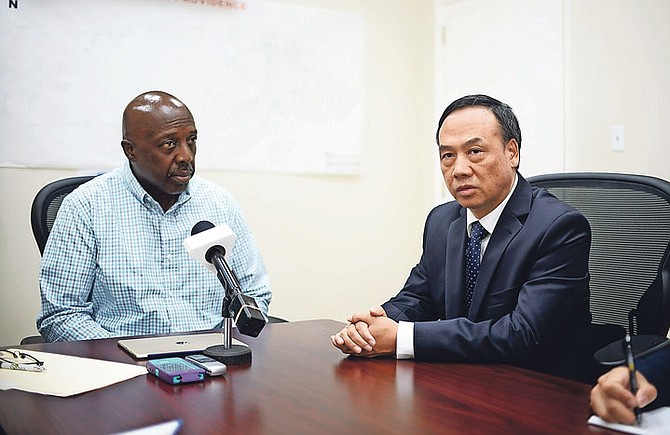 Chinese Ambassador to The Bahamas Huang Qinguo speaks yesterday as Hurricane Matthew Czar and Labour Minister Shane Gibson looks on. Photo: Shawn Hanna