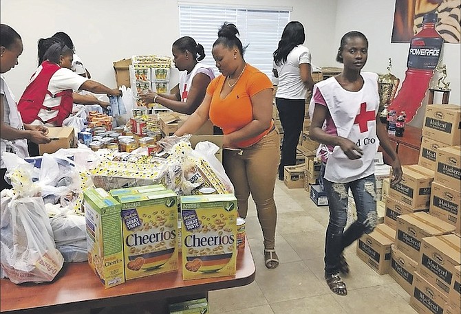 Bahamas Red Cross Grand Bahama volunteers assisting the CBC team with preparing the care packages.