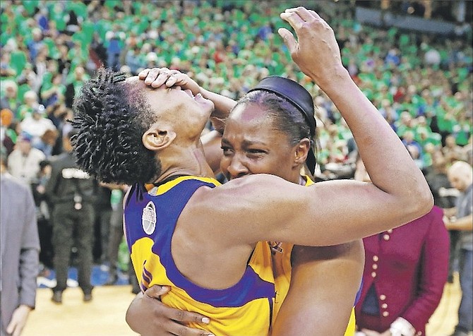 Sparks’ Alana Beard, left, and Chelsea Gray celebrate after the Sparks beat the Minnesota Lynx 77-76 to win the WNBA basketball finals last night in Minneapolis. 
(AP Photo/Jim Mone)