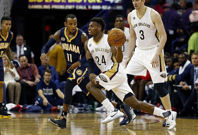 New Orleans Pelicans guard Buddy Hield (24) dribbles past Indiana Pacers guard Monta Ellis (11) during the first half of an NBA preseason basketball game in New Orleans, La., earlier this month. (AP)