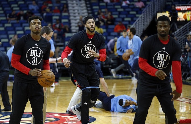 New Orleans Pelicans forward Anthony Davis, centre, guard Buddy Hield, left, and forward Solomon Hill, warm up before the game against the Denver Nuggets in New Orleans, Wednesday. (AP)