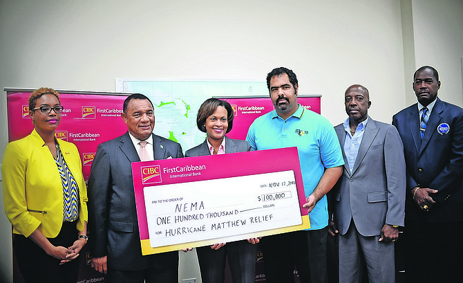 CIBC FirstCaribbean Managing Director Marie Rodland-Allen presents a $100,000 cheque to NEMA for post Hurricane Matthew relief and restoration work to Prime Minister Perry Christie and Gowon Bowe, member of the disaster relief committee responsible for the accounting and fund raising. Also pictured are Maya Nottage, CIBC FC Marketing and PR Manager (left); Shane Gibson, Minister responsible for Recovery and Restoration and Captain Stephen Russell, Director, NEMA. Photo: Shawn Hanna/The Tribune
              