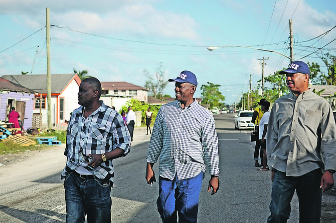 Stephen Dean, Assistant Commissioner (centre), and Superintendent Clayton Fernander (right) at the murder scene at Palm Tree Avenue on Sunday. Photo: Shawn Hanna/The Tribune