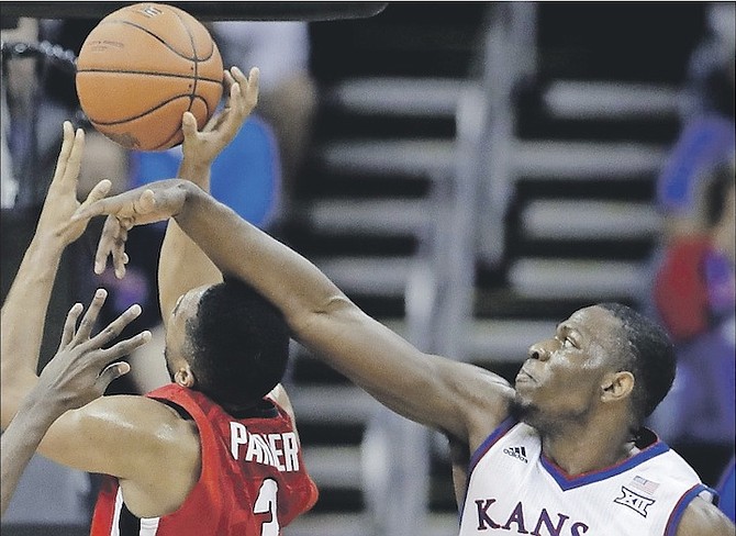 Kansas’ Dwight Coleby (22) and Lagerald Vick (2) pressure Georgia’s Juwan Parker (3) as he shoots during the first half of an NCAA college game on Tuesday in Kansas City, Mo. 
(AP Photo/Charlie Riedel)