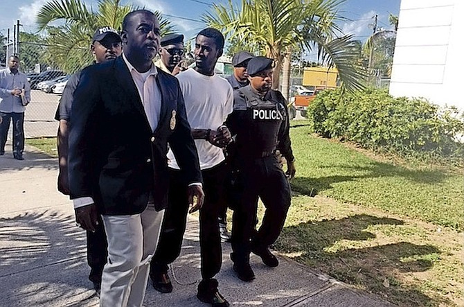 Marco Davis, 18, escorted by police into court Thursday. Photo: Lamech Johnson/Tribune Staff