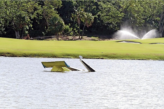 The wreckage of a plane at the golf course in western New Providence yesterday. 