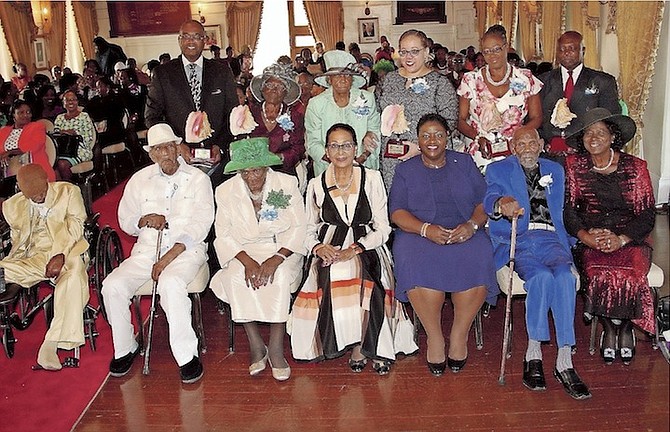 Governor General Dame Marguerite Pindling (fourth from right) and Minister of Social Services and Community Development Melanie Griffin pose for a photograph with those being honoured or their representatives at the Nation Builders Award Ceremony. Photo: Patrick Hanna/BIS