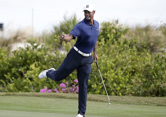 Tiger Woods reacts after saving par on the 16th hole during the second round at the Hero World Challenge golf tournament, Friday, Dec. 2, 2016, in Nassau, Bahamas. (AP Photo/Lynne Sladky)

