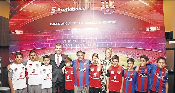 Winners of the Campeonato Nacional Futbol Scotiabank in Peru with Miguel Uccelli, general manager and CEO, and Barb Mason, group head of human resources, marketing and communications.