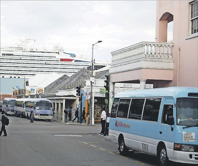 Jostling jitneys in downtown Nassau reveal a lack of co-ordinated transport schedules which leads to traffic congestion. 
Photo: Shawn Hanna/Tribune Staff