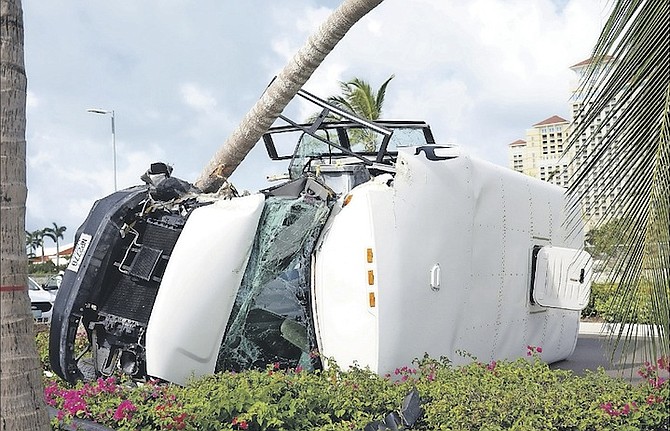 The wreckage of a bus carrying 24 students from St John’s College and a teacher. The bus overturned, hitting a tree on West Bay Street near Baha Mar. Photo: Shawn Hanna/Tribune Staff
