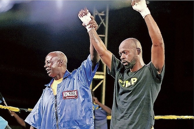 RAY MINUS JR holds up Meacher Major’s hand after he (Major Pain) won the main event to remain undefeated at home with a second round stoppage over Roberto Acevedo of Puerto Rico in the Caribbean Showdown boxing event at Kendal Isaacs Gym on Saturday night.   

 Photo: Shawn Hanna/The Tribune
