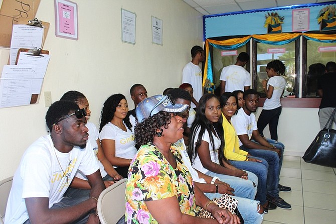 Ginger Moxey, in yellow, centre, with supporters registering to vote in Grand Bahama on Wednesday as she declared she was vying to become the Progressive Liberal Party candidate for Central Grand Bahama. See full story on page three. 
