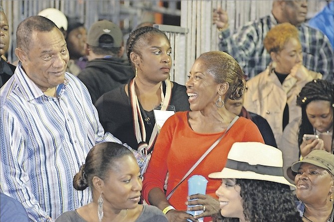Prime Minister Perry Christie chatting with Patricia Minnis, wife of FNM leader Dr Hubert Minnis at the New Year Junkanoo parade on Bay Street yesterday morning. 
Photo: Peter Ramsay/BIS