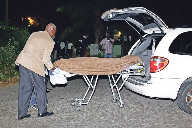 The body of a man found shot dead off southern Kemp Road on Wednesday night is taken away. Photo: Terrel W Carey/Tribune Staff 