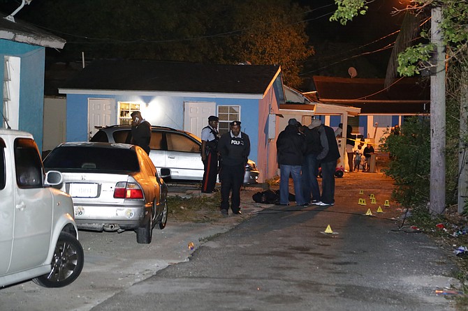 Police at the scene of the fatal shooting of a young man on Williams Lane early on Wednesday. Photo: Terrel W Carey/Tribune Staff