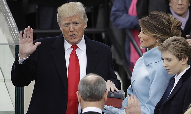 Donald Trump is sworn in as the 45th president of the United States by Chief Justice John Roberts as Melania Trump looks on during the 58th Presidential Inauguration at the U.S. Capitol in Washington, Friday, Jan. 20, 2017. (AP Photo/Matt Rourke) '
