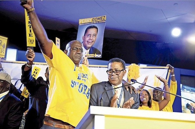 A supporter catches the limelight as Minister of Health Dr Perry Gomez prepares to speak at the PLP convention. 
Photo: Shawn Hanna/Tribune Staff