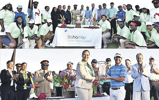 CHAMPION: Andrew Landry receives his trophy from Joy Jibrilu, director general of tourism, after winning the Bahamas Great Abaco Classic on Wednesday.
                                                                                                                                                                                                                                                                                Photos: Kemuel Stubbs 
