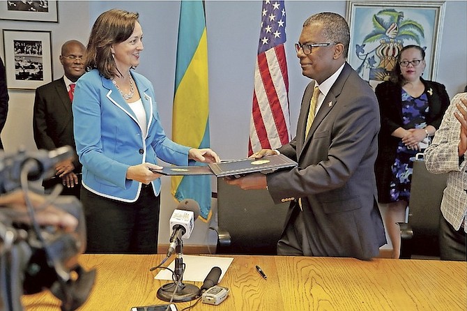 The signing of the AUTEC lease renewal yesterday, as the signed leases are exchanged between Minister of Foreign Affairs Fred Mitchell and US Chargé d’Affaires Lisa Johnson of the US Embassy. Photo: Terrel W. Carey/Tribune Staff