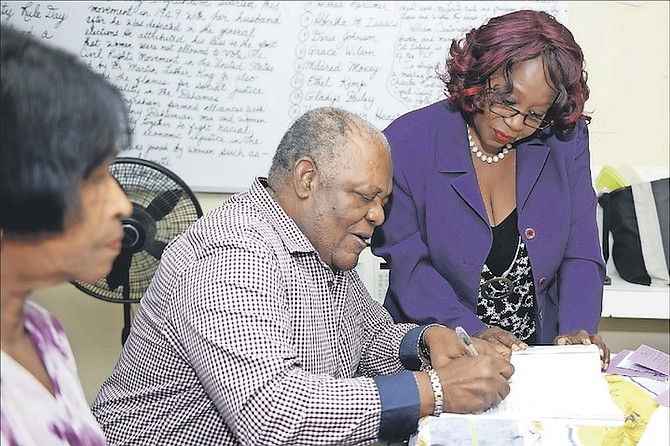 Hubert Ingraham, former Prime Minister of The Bahamas, registering to vote with his wife Delores at Government High School. Photo: Shawn Hanna/Tribune Staff