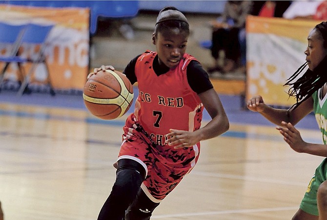 GOING HARD: The St Augustine’s College Big Red Machine junior girls yesterday closed out a two-game sweep of the defending champions Queen’s College Comets with a 37-26 win at the Kendal Isaacs Gymnasium.
                                                                                          Photo: Terrel W Carey/Tribune Staff
