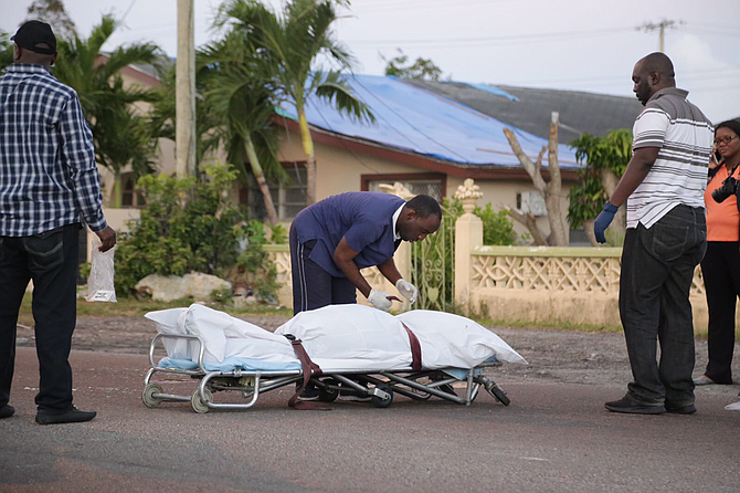 The body of the dead man is carried away from the scene of the shooting on Bamboo Boulevard on Wednesday morning. Photo: Terrel W Carey/Tribune Staff