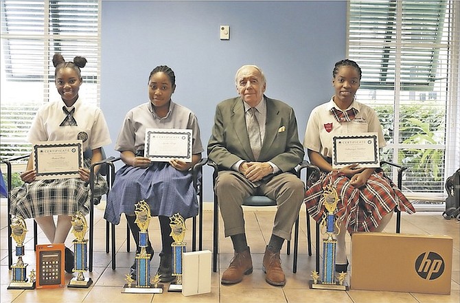 Winners of the first Economics Essay Competition pictured with Peter Young, director of the Nassau Institute and former British High Commissioner. Students pictured from left are third place wubber Sherica Rose, 16-year-old 11th grader of Doris Johnson Senior High School, second place winner Ayesha Kemp, 17-year-old 12th grader of Anatol Rodgers High School and first place winner Caltranique Gardiner, 18-year-old 12th grader of Westminister College. Photo: Terrel W. Carey/Tribune Staff