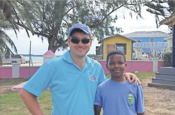 Jeff Todd, left, director of communications at GIV Bahamas Inc, with Cameron Williams after he finished the gruelling Tour de Turquiose 50km race.
