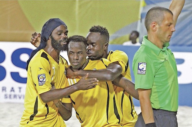 VICTORY SWEET: Team Bahamas players (l-r) Nesly Jean, Lesly St Fleur and Gary Joseph celebrate yesterday as they prevailed with a 3-0 win over Belize in CONCACAF Beach Soccer Championship.                                              The Bahamas advanced to the quarter-finals.