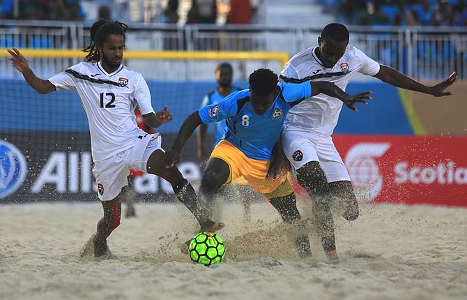 Dwayne Forbes, of the Bahamas, tries to get between two Trinidad & Tobago players in the CONCACAF Beach Soccer Championship on Saturday evening