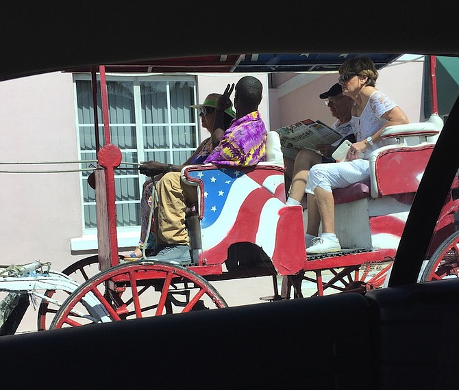 An overloaded Surrey in downtown Nassau last week. Drivers are only permitted to take two adults (or two adults and two children under 14) on a ride.