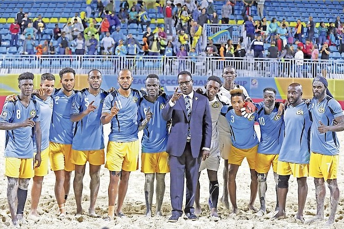 Minister of Youth, Sports and Culture Dr Daniel Johnson with members of the men’s national beach soccer team. 
                                                                                                                                                                                                         Photo: Terrel W Carey/Tribune Staff