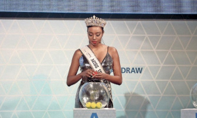 MISS BAHAMAS Universe 2016 Cherell Williamson does the honours of picking the positions in which the teams were placed in the four groups for the FIFA Beach Soccer World Cup.
Photo: Shawn Hanna/Tribune Staff