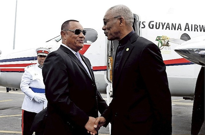 Prime Minister Perry Christie shakes the hand of Guyana President David A Granger as he prepares to depart from the Lynden Pindling International Airport. Photos: Shawn Hanna/Tribune Staff