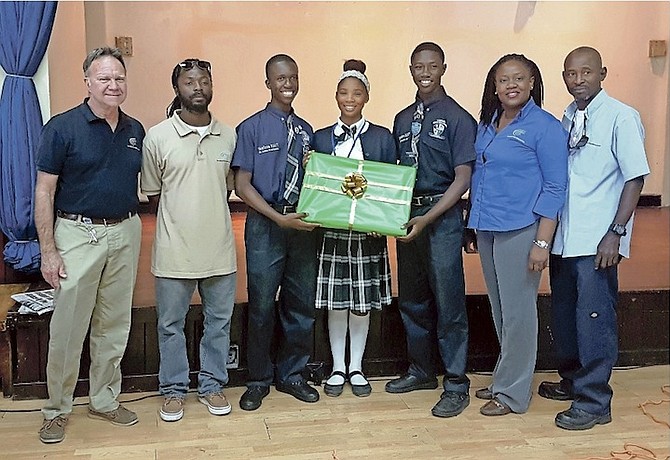 Bryan Russell, general manager, Consolidated Water (CWCO); Deno Campbell, CWCO store inventory manager; CV Bethel students Simeon Farquharson, Jasper King and Raquille Sands; Welliya Cargill, CWCO administrative assistant; and Jeffrey Burrows CWCO operations supervisor at the C V Bethel science and technology seminar. Photo: Samone Davis/SW PR.
