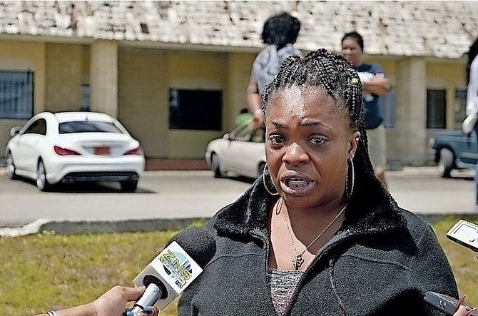 Karen Basden becomes emotional while speaking to the media in Grand Bahama. 