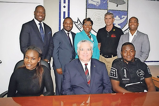 The Rotary Bahamas Road to Peace Committee in conjunction with the Rotary Bahamas Scholarship Committee has afforded two residents of Bain and Grants Town the opportunity to pursue a professional development course at the Bahamas Technical and Vocational Institute (BTVI).  From left, standing: past assistant governor and committee co-chair Stan Charlton; past president Jamaal Davis; committee member and BTVI’s associate vice-president of fund development Alicia Thompson; committee member Mike Russell and assistant governor Tim Ingraham (seated) scholarship recipient Yasmine Williams; BTVI president Dr Robert W Robertson and scholarship recipient Lerenzo Charles.