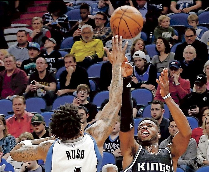 Kings’ Buddy Hield, right, shoots over Timberwolves’ Brandon Rush during the first half of Saturday’s game in Minneapolis. 
 (AP Photo/Jim Mone)