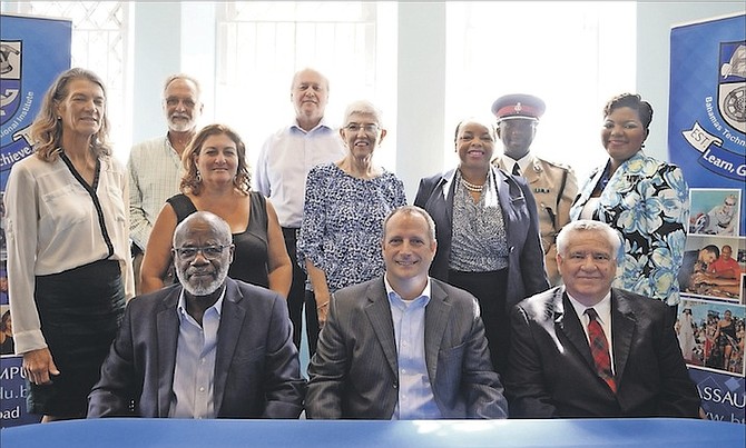 Seated from left, Ranfurly Homes’ administrator Alexander Roberts; St Andrew’s Presbyterian Kirk Reverend Byrn McPhail and BTVI president Dr Robert Robertson. In the second row, from left, Kirk and Ranfurly Homes’ board member Linda Eldon; Ranfurly Homes’ president Alexandria Maillis-Lynch; Kirk elder Margaret McKinney; Sigma Gamma Rho president Tanya Woodside and BTVI’s associate vice-president of fund development Alicia Thompson. At the rear are Kirk management committee chairman Peter Bates; Kirk elder Tim Lightbourn and assistant sof police and chairman of the Bain and Grants Town Scholarship Fund Anthony Rolle. Photo: Shawn Hanna/Tribune Staff