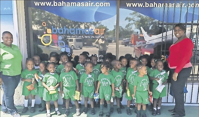 Mrs A Rolle (left) and Briel Jacques (right) with the Willard Patton Pre-School students outside Bahamasair.