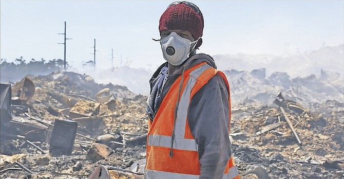 A worker in a protective mask at a dump fire earlier this year.
Photo: Terrel W. Carey/Tribune Staff